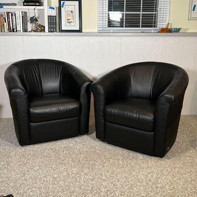PAIR ITALSOFA CHAIRS | Black leather armchairs, barrel back, swiveling, in overall very good condition; h. 31-1/2 x w. 34 x d. 26 in.