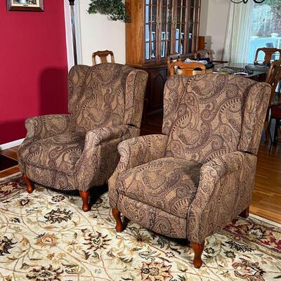 PAIR RECLINING ARMCHAIRS | Wingback reclining armchairs having textured paisley upholstery, fronted by two short cabriole legs, with...