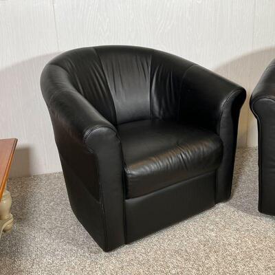 PAIR ITALSOFA CHAIRS | Black leather armchairs, barrel back, swiveling, in overall very good condition; h. 31-1/2 x w. 34 x d. 26 in.