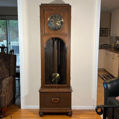 GERMAN TALL CASE CLOCK | Wood case with a beveled glass door, 8 rod chimes, brass pendulum, the face with Arabic numerals [replaced...
