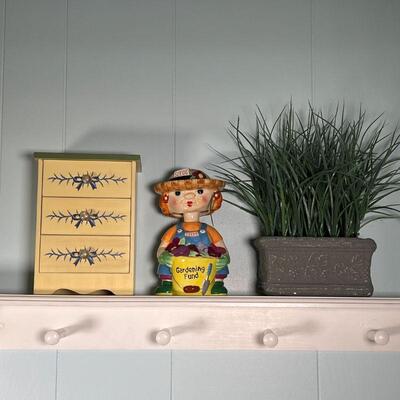 (3pc) SHELF DECOR | Including a faux plant, a gardening figure piggy bank, and a painted miniature chest of drawers (h. 8 x w. 6 in.)
