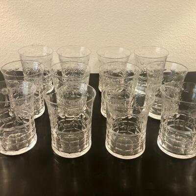 A dozen etched glass holiday barware glasses