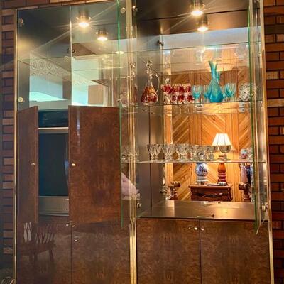 Two wood, brass, and glass wall units with mirrored backs. Purchased in late 70s to match Italian marshmallow sofa, chairs, coffee table,...