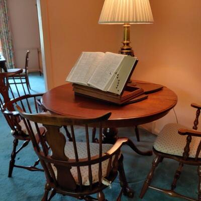 Beautiful rd cherry rd.   table with leaves and 4 chairs.$500 . Drexel book stand $100.