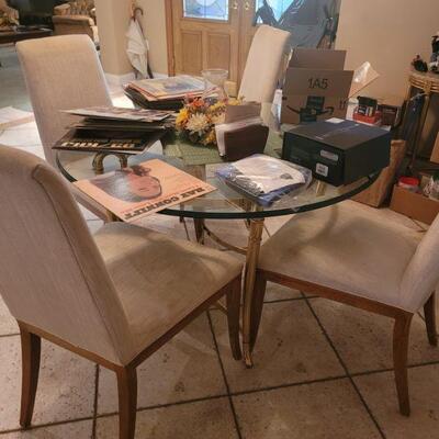 dining room table with triple bevel glass top and four chairs. Seats on the chairs need to be cleaned