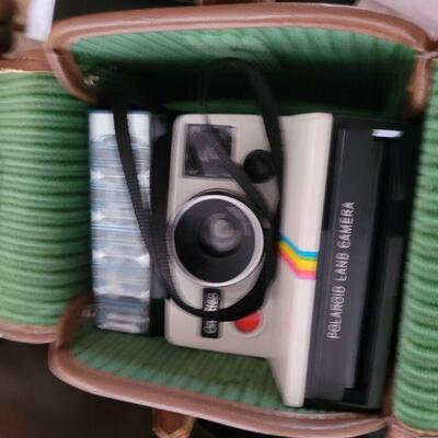 an old Polaroid camera, in the case