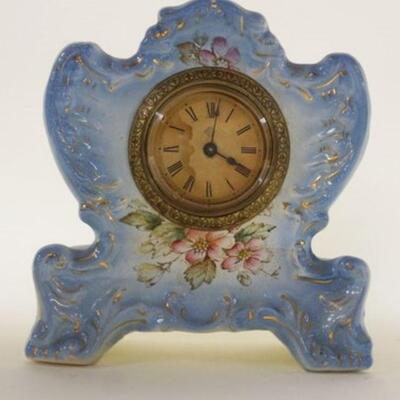 1128	ANSONIA MINIATURE CHINA CLOCK, CHICADEE, APPROXIMATELY 6 IN X 2 IN X 6 1/4 IN HIGH

