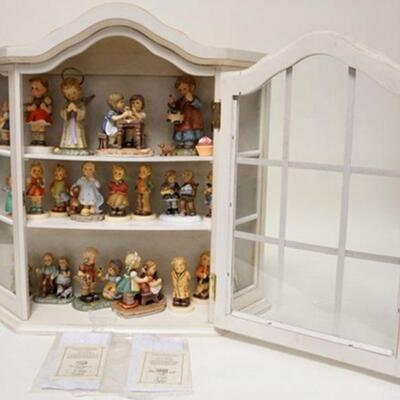 1234	HANGING CABINET W/21 HUMMEL FIGURES, CABINET IS 21 1/2 IN WIDE X 20 3/4 IN HIGH
