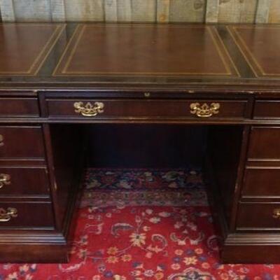1180	SLIGH MAHOGANY LEATHER TOP DESK, 7 DRAWER, WEAR TO ONE LEATHER PANEL, APPROXIMATELY 60 IN X 30 IN X 31 IN HIGH
