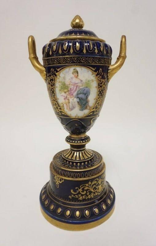 1004	ROYAL VIENNA PAINTED PORCELAIN BOLTED URN, APPROXIMATELY 14 IN HIGH
