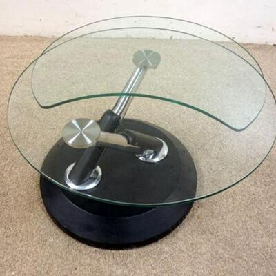 1059	UNUSUAL MODERN STYLE GLASS TABLE. HAS A CANTILEVER THAT SWIVELS TO OPEN. APPROXIMATELY 27 1/2 IN X 17 1/2 IN HIGH
