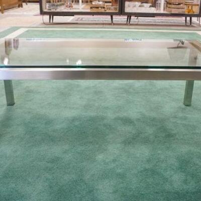 1030	MODERN GLASS TOP COFFEE TABLE W/POLISHED STEEL BASE, APPROXIMATELY 47 IN X 26 IN X 17 IN HIGH

