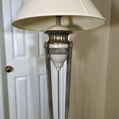 ITALIANATE FLOOR LAMP | Small urn resting on four long torch-form rods joined on a gilt scalloped base; overall h. 63 in.