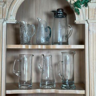 (6pc) GLASS PITCHERS | Crystal, blown glass, and glass pitchers of various sizes and forms; largest h. 12 in.