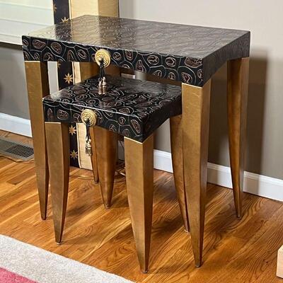 (2pc) NESTING SIDE TABLES | Carved reptilian style black color wood top, gold painted tapered legs, gilt accent with tassel; large table...