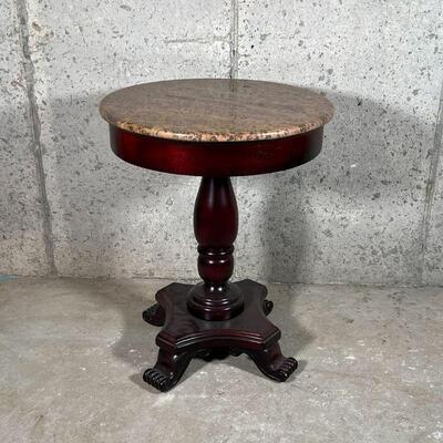 STONE PEDESTAL TABLE | Textured stone top over a turned wood pedestal and four carved feet; dia. 22 x h. 28 in.