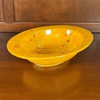 HAND PAINTED SERVING BOWL | Large ceramic bowl hand painted yellow with sprawling vines of roses, signed and dated on the bottom; l. 14 in.