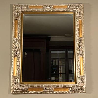 GILT WALL MIRROR | Very large gilt carved wall mirror with floral scrollwork carved accents and beveled glass; 52 x 42 in.