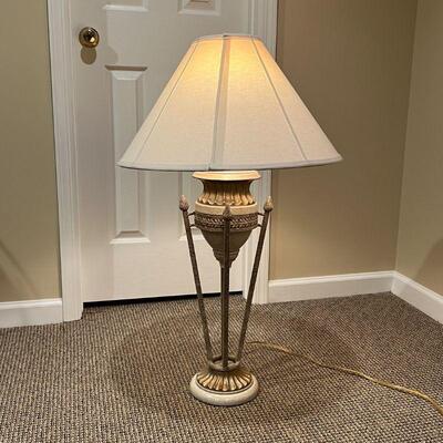 ITALIANATE TABLE LAMP | Designed as a small urn resting on four torch-form rods on a gilt base; overall h. 36 in.