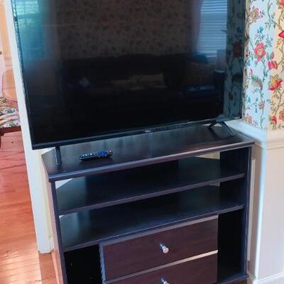ALMOST NEW SMART TV WITH REMOTE AND CABINET STAND