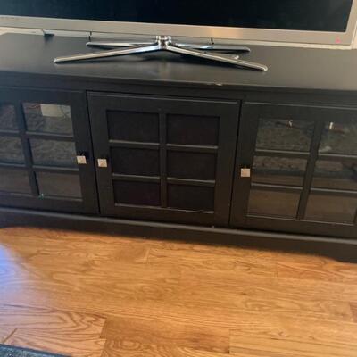 Hardwood television stand with ample storage and glass doors. 60 x 21 x 26 $100