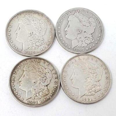 #1355 â€¢ (4) 1885-1921 Morgan Silver Dollars. Includes: (1) 1885, Philadelphia Mints, (1) 1897, New Orleans Mints, (1) 1921,...