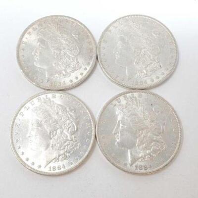 #1296 â€¢ (4) 1884 Morgan Silver Dollars, 107g. Weighs Approx: 107g New Orleans Mints. 