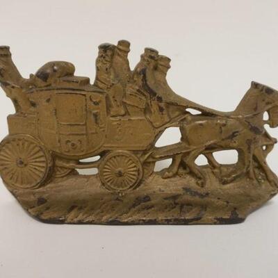 1007	CAST IRON DOORSTOP ENGLISH COACH SCENE, MARKED ON REVERSE WH HOWELL CO, APPROXIMATELY 7 IN X 4 IN HIGH
