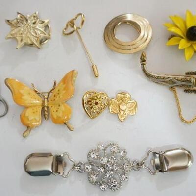 1304	LADIES COSTUME JEWELRY INCLUDING PINS, STICK PIN, SCARF CLASPS AND GIRL SCOUT PIN
