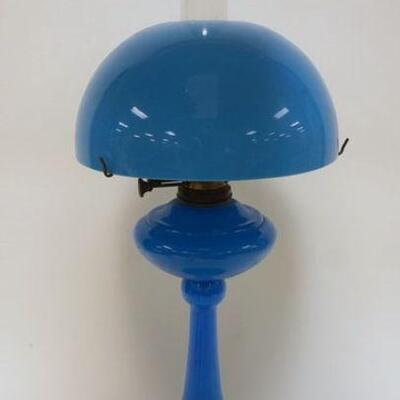 1008	ANTIQUE KEROSENE LAMP W/OPAQUE BLUE GLASS SHADE & LAMP, LAMP HAS EM DUPLEX BURNER, APPROXIMATELY 27 1/2 IN HIGH

