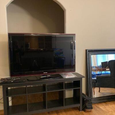 TV, stand, and large mirror
