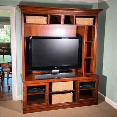 BASSETT FURNITURE MEDIA CABINET| Solid wood entertainment center with a dark finish, with shelving above and alongside the TV area, all...