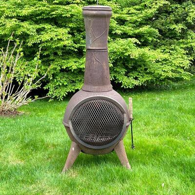 CAST IRON CHIMINEA | Chimney-form outdoor wood burning fire pit, on three legs; h. 46 in.