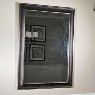 FRAMED WALL MIRROR | Beveled glass mirror in a brown and gold finished wood frame; h. 41 x 29 in.