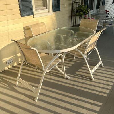 OUTDOOR DINING SUITE | Telescope Casual patio dining set, including a glass top table of oval shape with 4 stacking chairs, in very good...