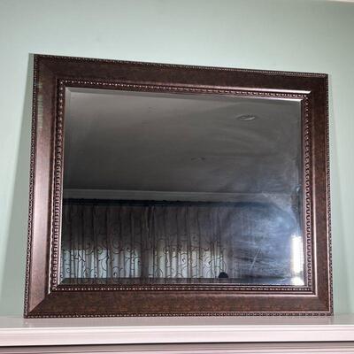 BEVELED GLASS MIRROR | Wall mirror with dark a brown metal frame; overall h. 28-1/4 x 34 in.