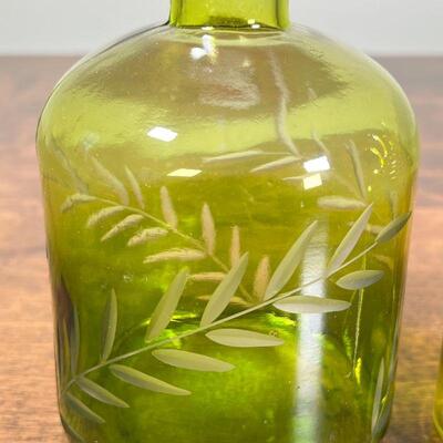 (2pc) GREEN GLASS BOTTLES | Molded green glass, including one with cut viney decorations; largest 6 in.