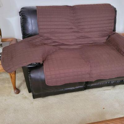 Loveseat with a cover over it