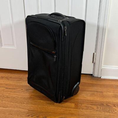 TUMI CARRY-ON | Black Tumi carry on suitcase, rolling; h. 23 x 14 x 9-1/2 in.