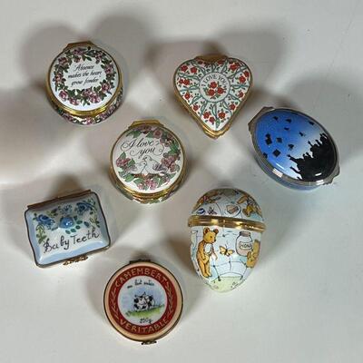 (7pc) PORCELAIN BOXES | Small enameled porcelain trinket boxes, mostly Halcyon Days Enamels, and including a French Camembert Veritable...