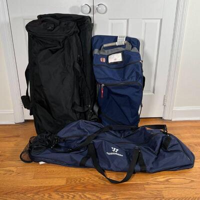 (3pc) SPORTS BAGS | Including a blue Burton rolling bag, a large Tumi rolling duffle bag (approx. l. 34 in.), and a long blue Warrior...
