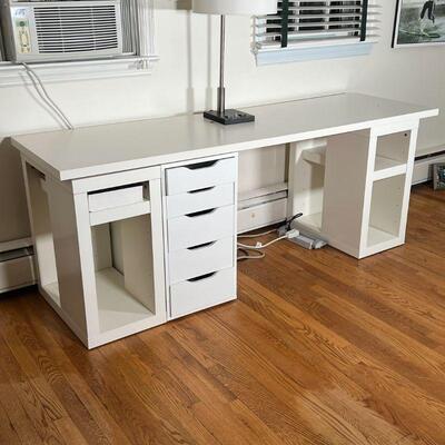 WHITE IKEA DESK | Large work top resting on three base sections, including one stand with five drawers and two shelving units; overall h....