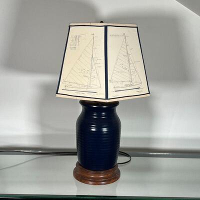 POTTERY TABLE LAMP | Ribbed blue pottery jar on a wood stand and mounted as a lamp with a unique sailboat hexagonal-shaped lampshade;...