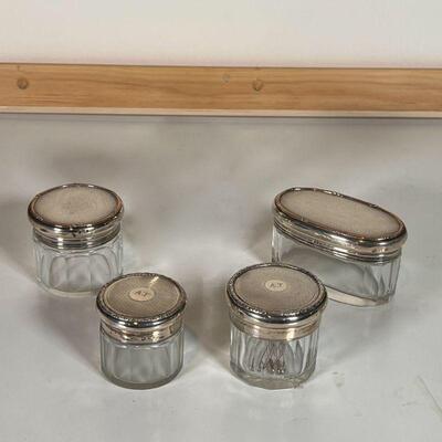 (4pc) SILVER LIDDED JARS | Small glass jars, each with an engine turned sterling silver lid with English hallmarks