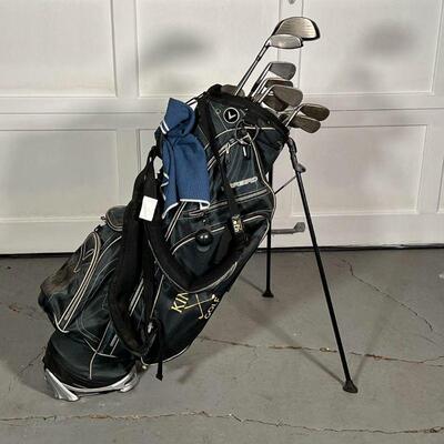 GOLF CLUBS & BAG | A collection of golf clubs: Titleist (including Titanium 983K), TaylorMade, a Tom Austin Cleveland, and Mizuno; all in...