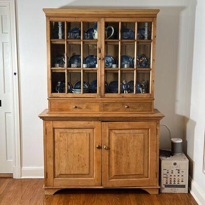 PINE HUTCH CABINET | In two sections, with two glass doors before three shelves over two drawers, the lower section with double cabinet...