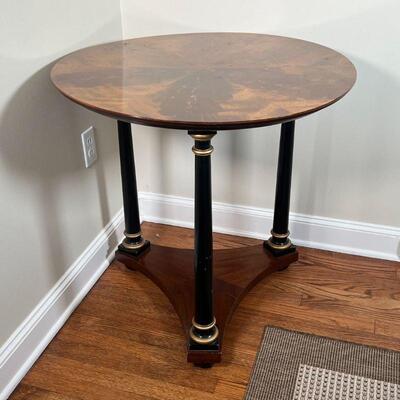 ROUND HALL TABLE | Burlwood veneer top on three ebonized and gilt legs joined at the base; h. 29 x dia. 27-1/2 in.