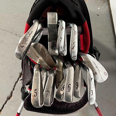 SET of GOLF CLUBS | A collection of Titleist golf clubs, including Vokey Design, as well as TaylorMade, Z|I Theta, and Mizuno clubs, in a...