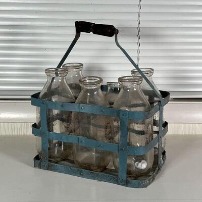 MILK BOTTLES & CARRIER | Six bottle carrier with five R.J. Sayre glass bottles and a Ronny Brook bottle; overall h. 14 x 12 x 8 in.