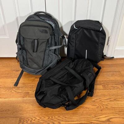 (3pc) BACKPACKS & BAGS | Including a black backpack, a black Briggs & Riley duffle bag, and a grey North Face backpack